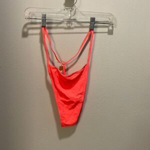 Nwt Skims woman’s thong underwear in the color nectarine. It’s a neon pink color